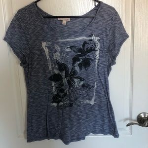 grey shirt with flower on the front